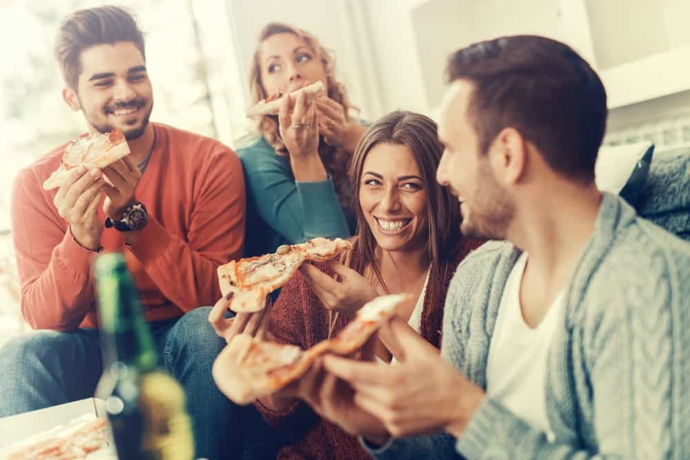 Friends eating pizza and having fun