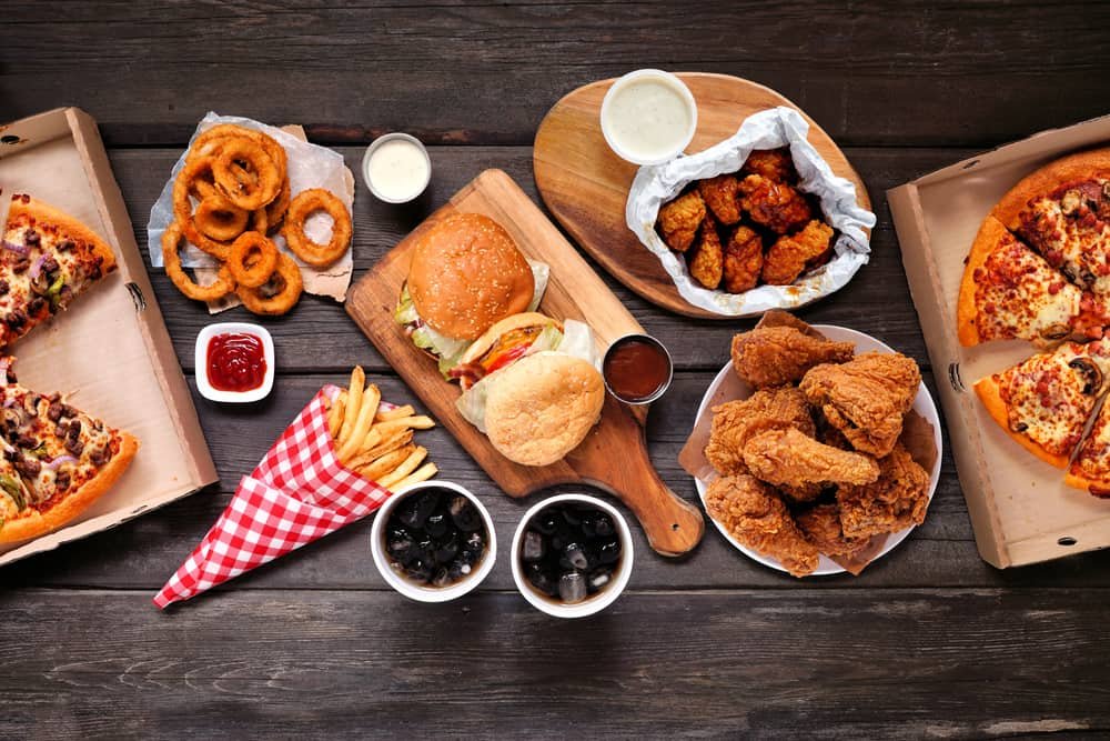 Table scene with large variety of take out and fast foods